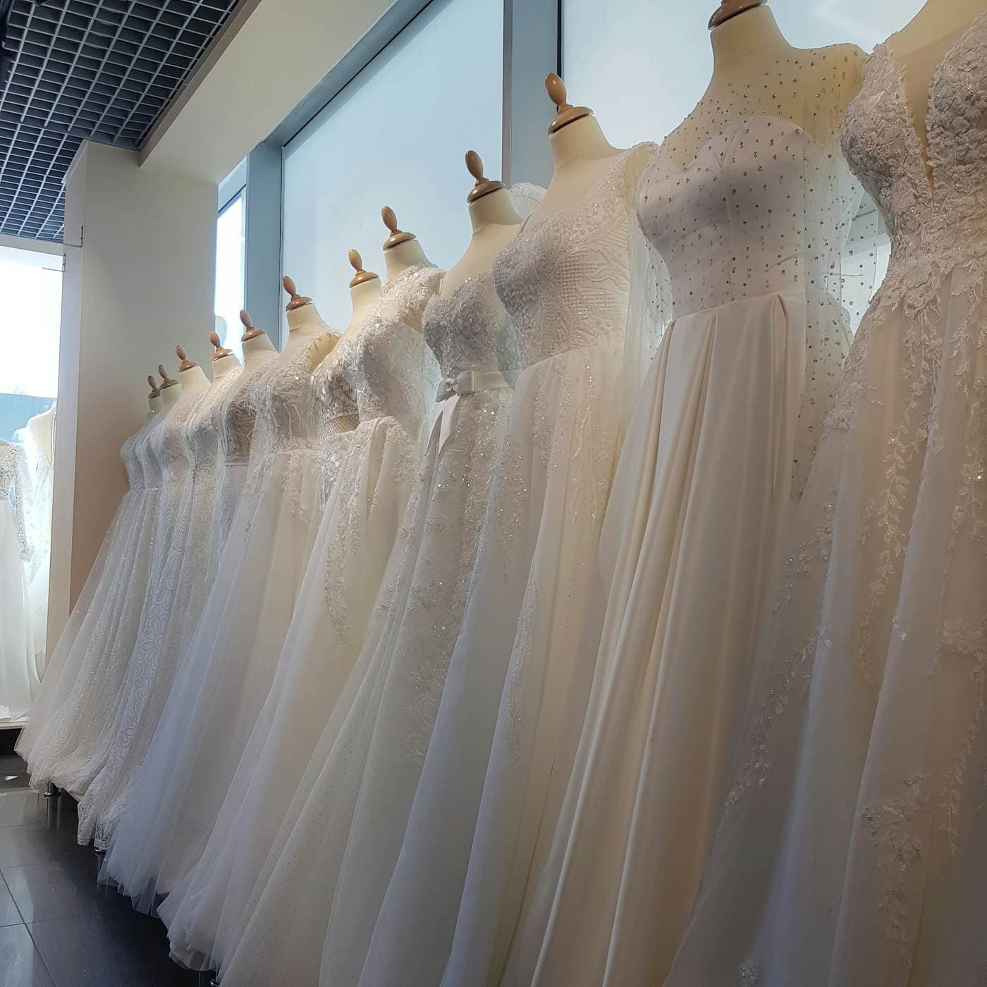 Row of sample gowns on mannequins
