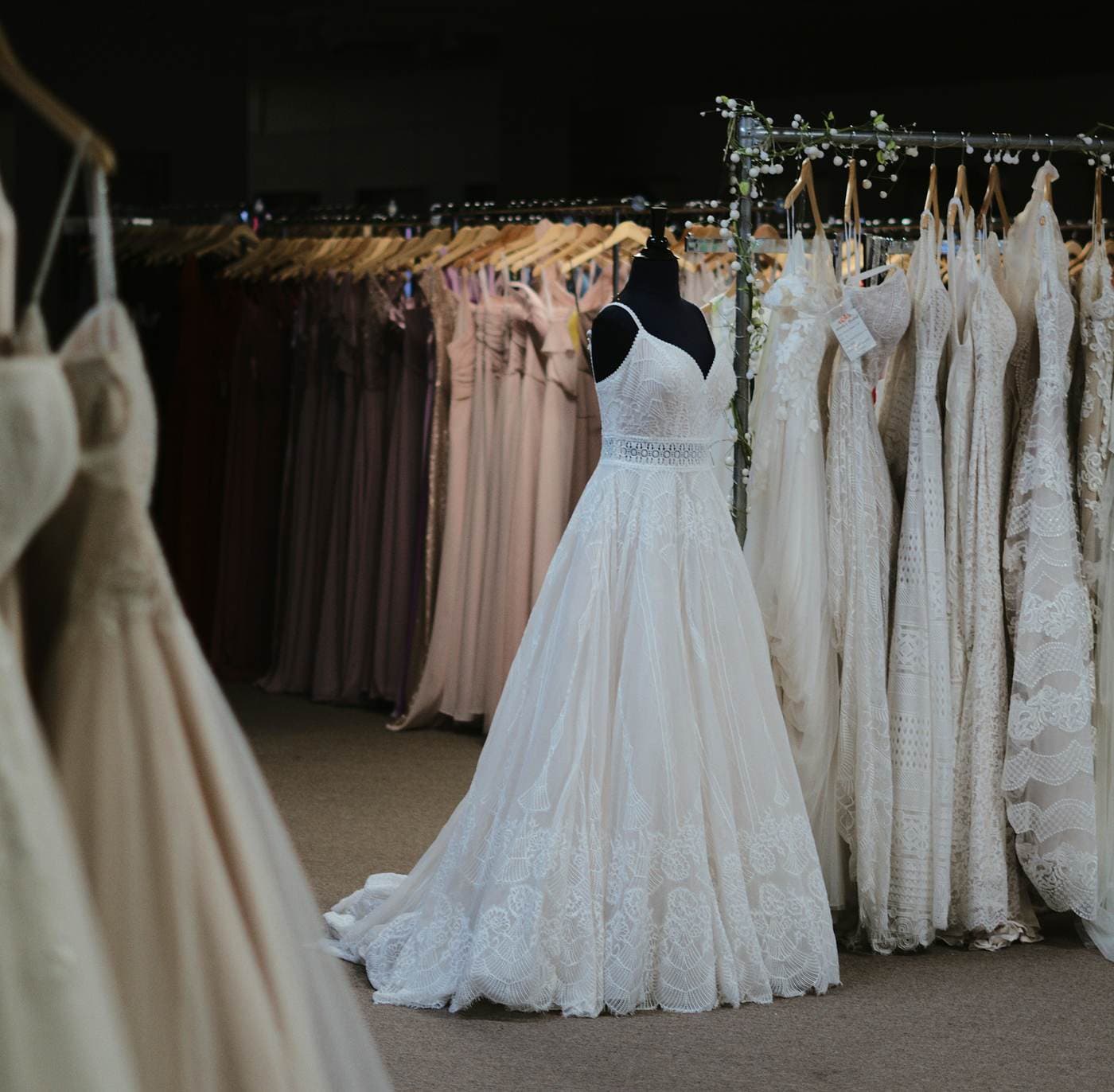 Curated sample gowns on a boutique rack